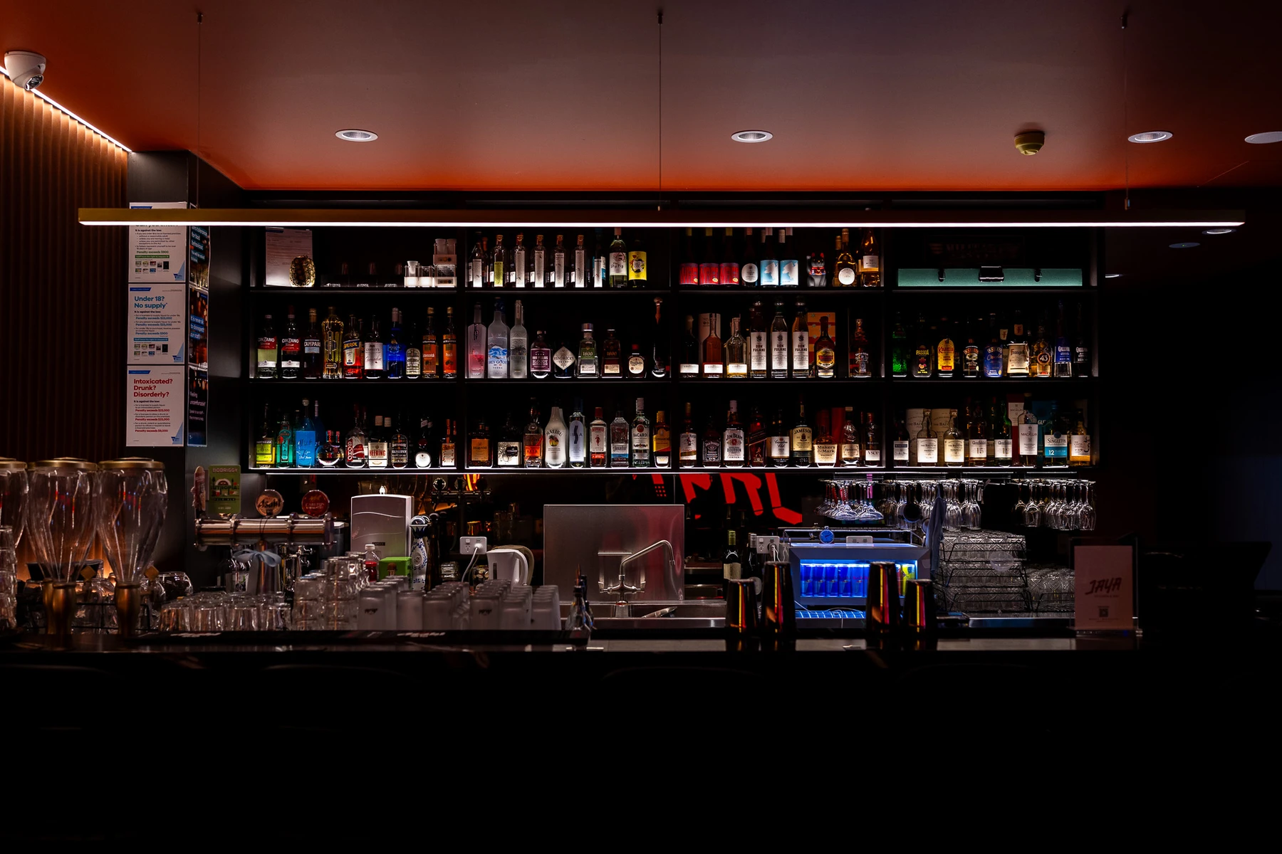 The illuminated bottle wall and bar at Jaya