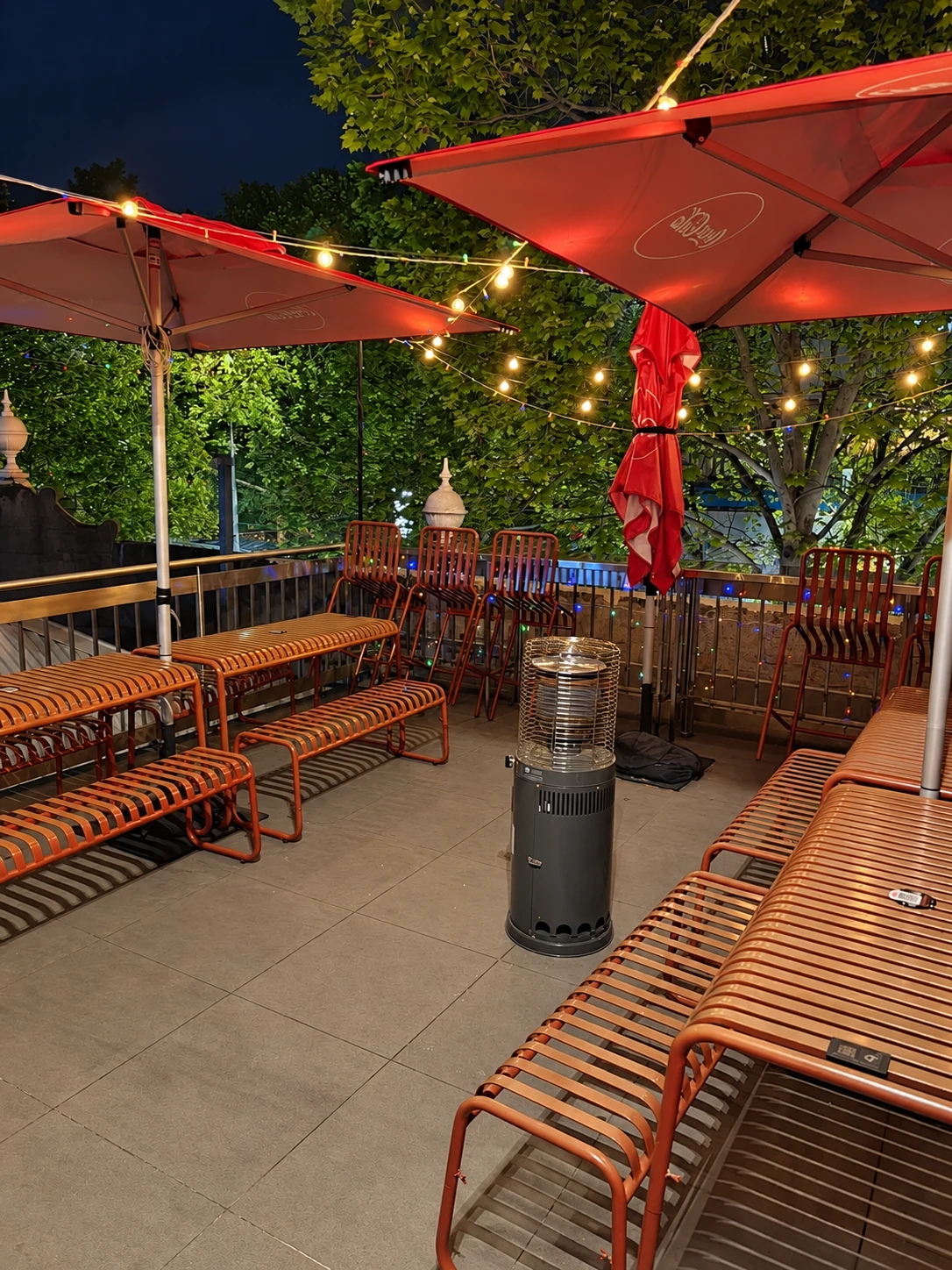 Jaya’s outdoor seating beneath red umbrellas and string lights
